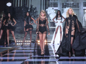 Taylor Swift and her bestie Karlie Kloss walking down the runway dressed in Black lingerie