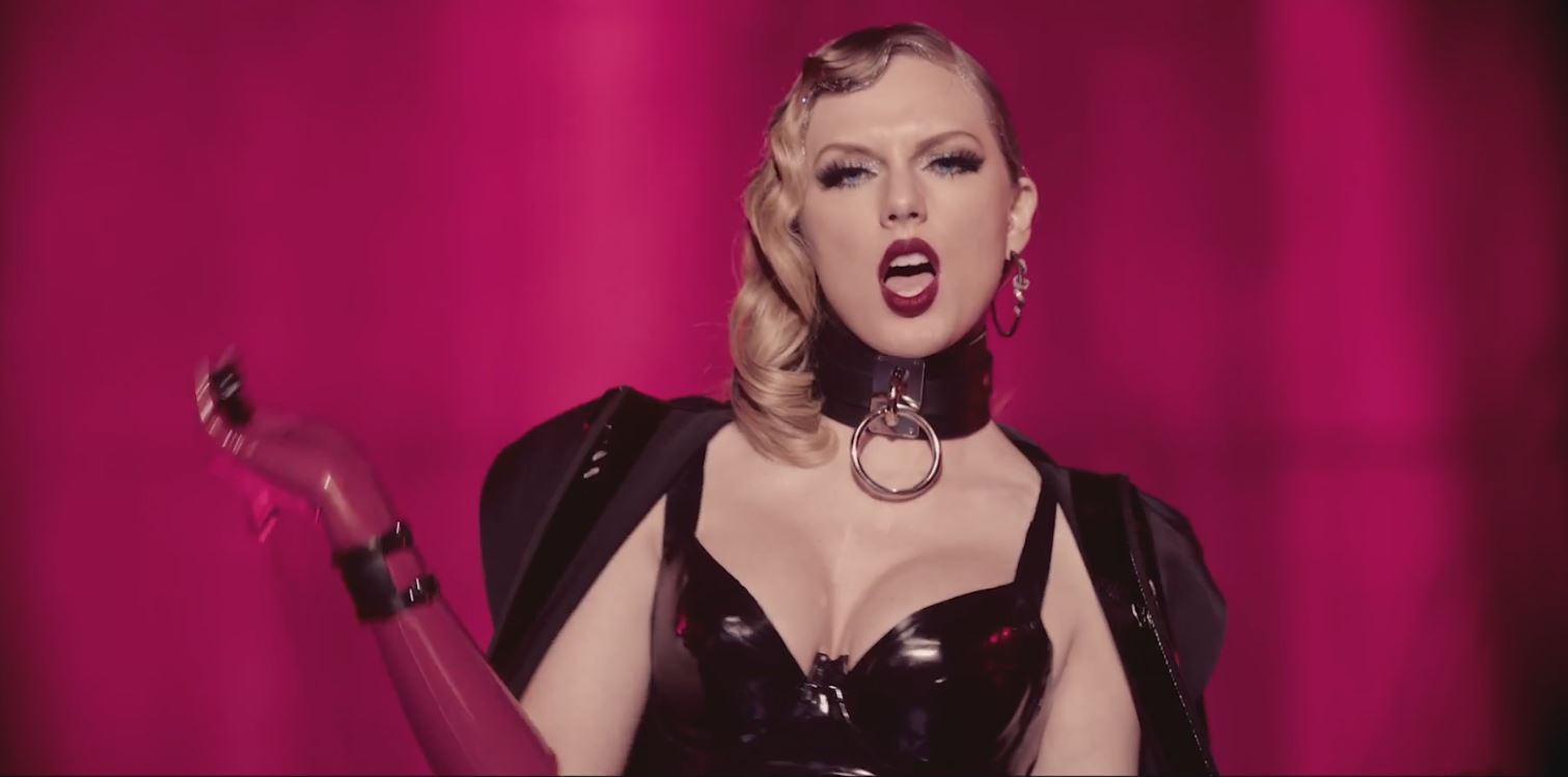 Taylor Swift wearing latex and holding a whip in LWYMMD video